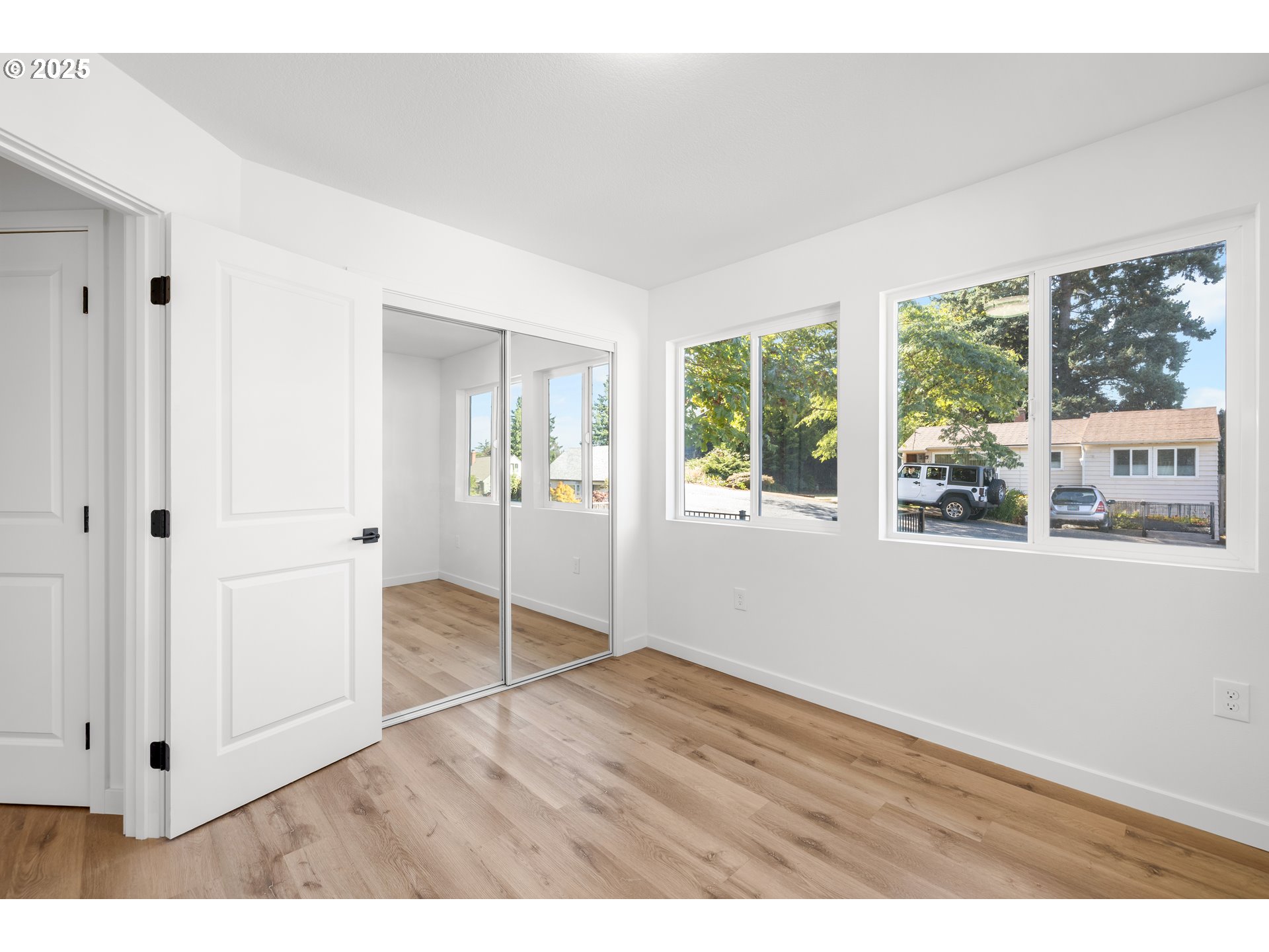 142 Northeast 128th Avenue Portland, OR 97230 - Photo 25 of 43 an empty room with wooden floor and windows
