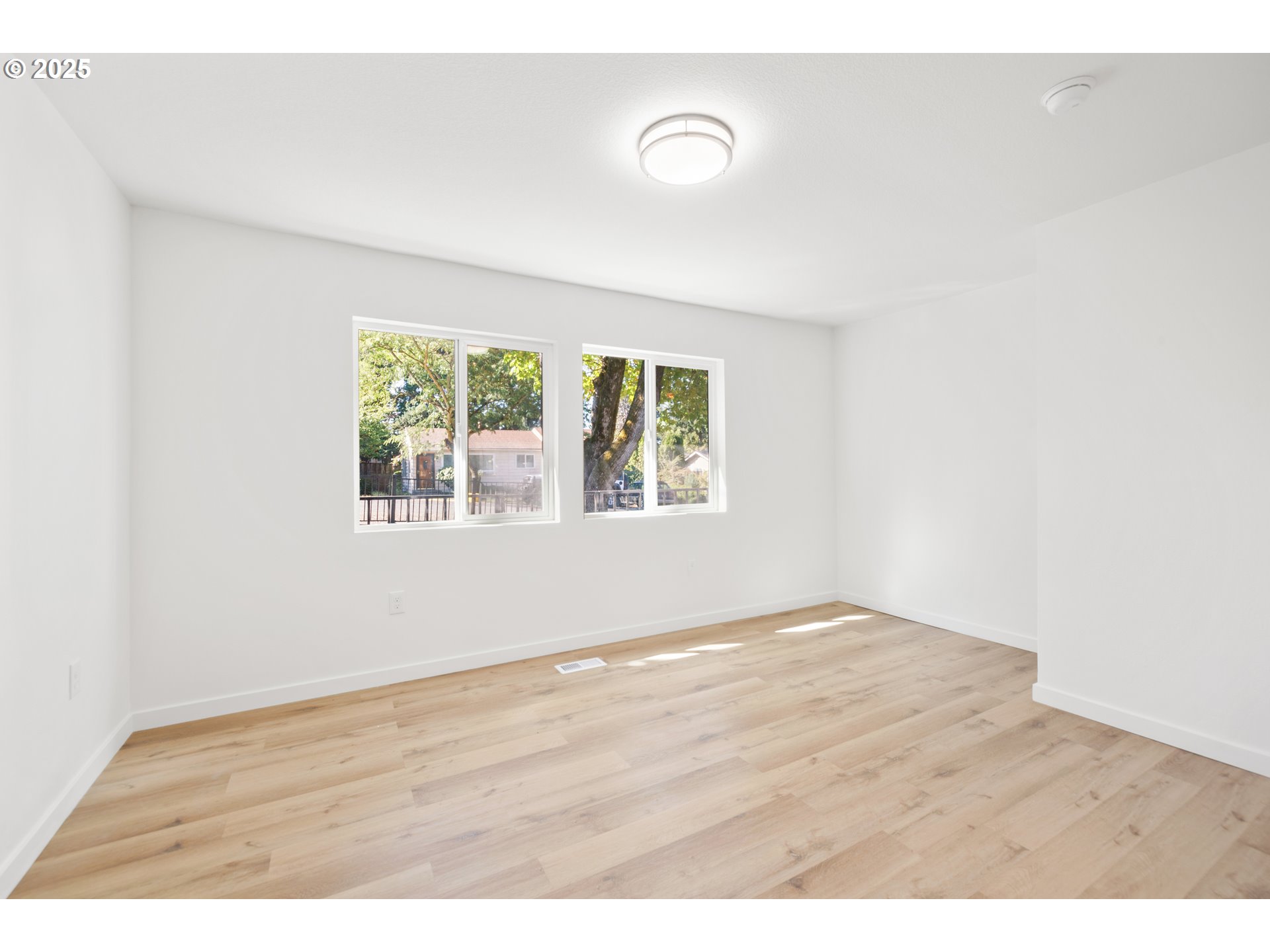 142 Northeast 128th Avenue Portland, OR 97230 - Photo 27 of 43 a view of an empty room with wooden floor and a window