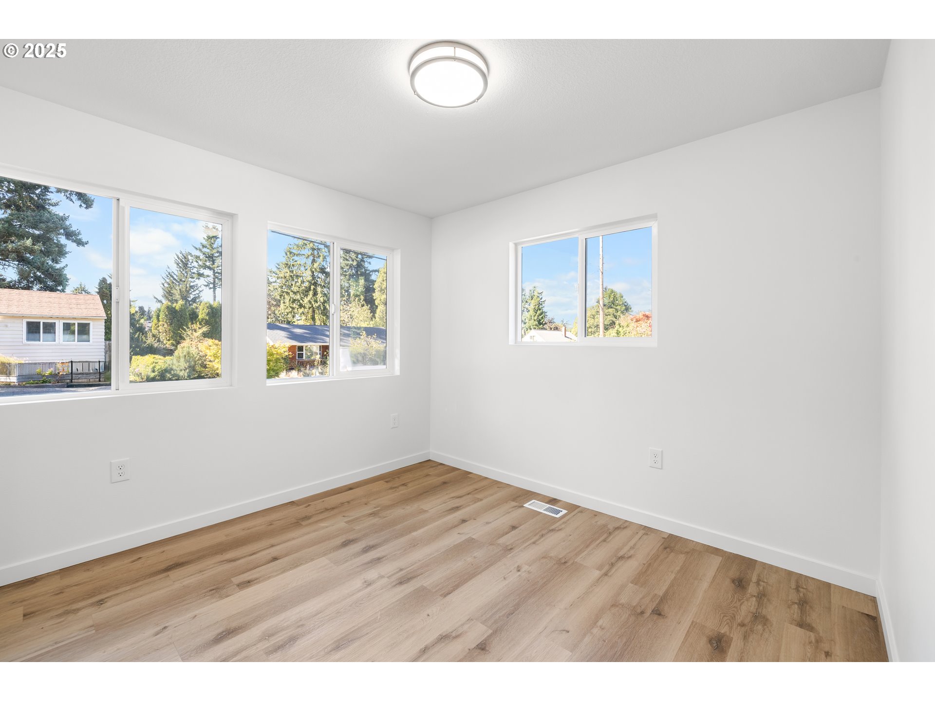 142 Northeast 128th Avenue Portland, OR 97230 - Photo 32 of 43 an empty room with wooden floor and windows