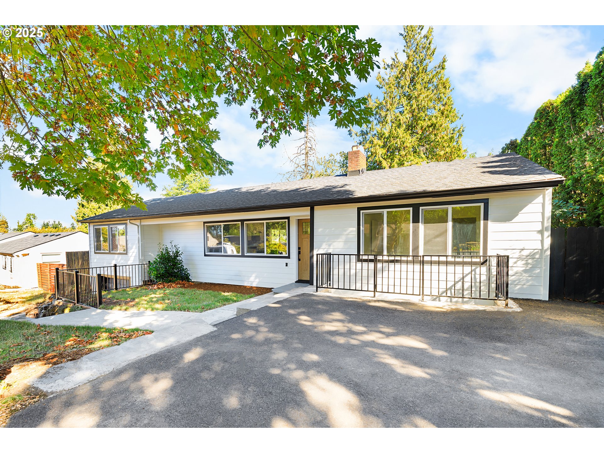 142 Northeast 128th Avenue Portland, OR 97230 - Photo 4 of 43 a front view of a house with a garden