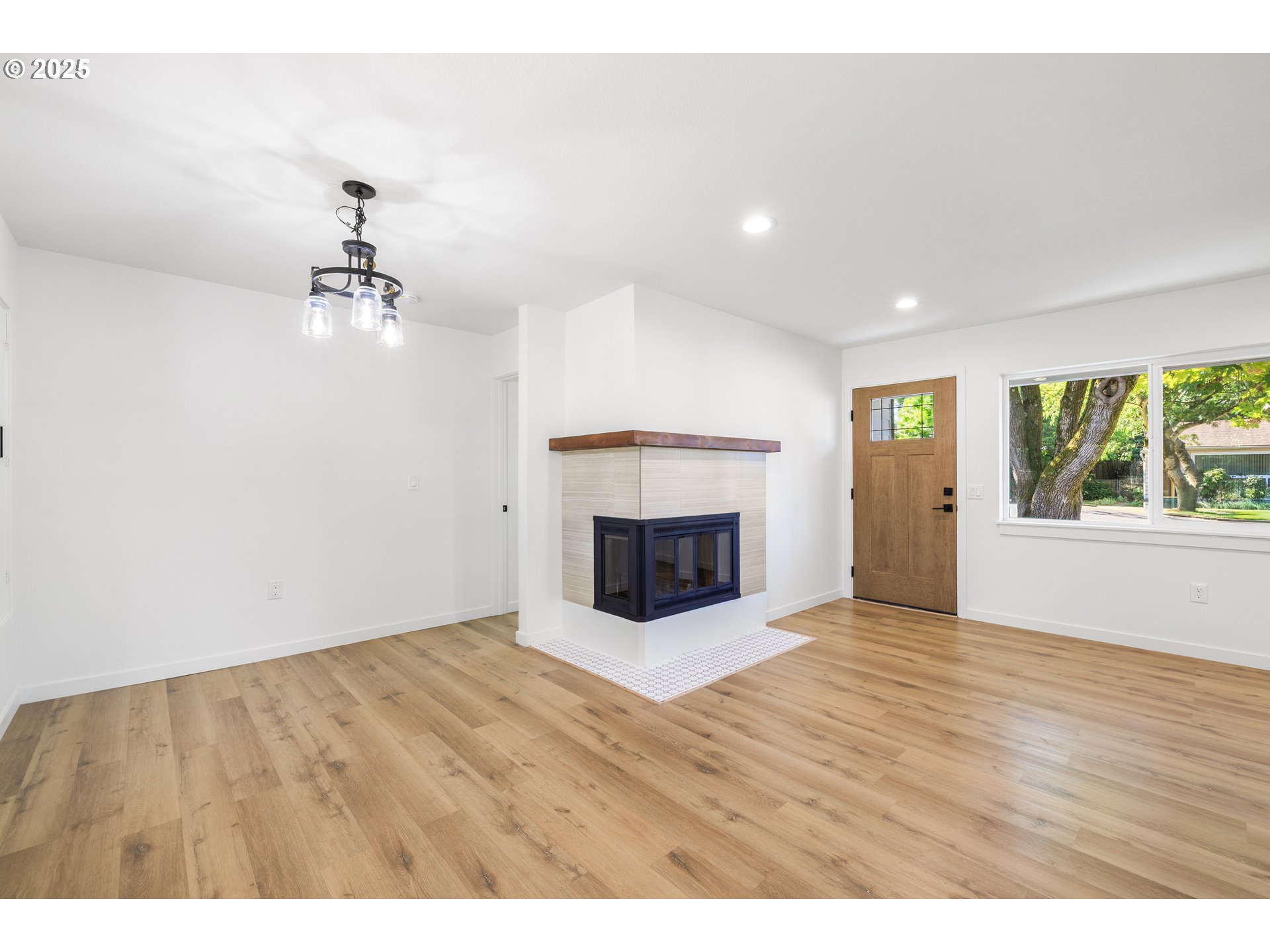 142 Northeast 128th Avenue Portland, OR 97230 - Photo 6 of 43 a view of an empty room with a fireplace and a window
