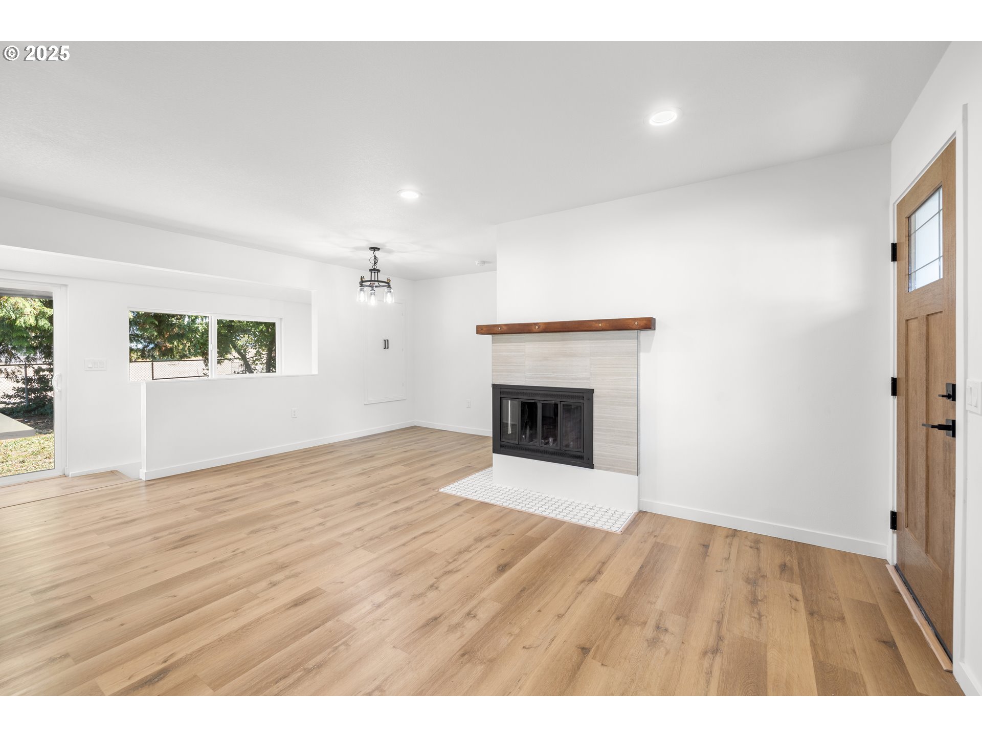 142 Northeast 128th Avenue Portland, OR 97230 - Photo 7 of 43 a view of empty room with wooden floor and fireplace