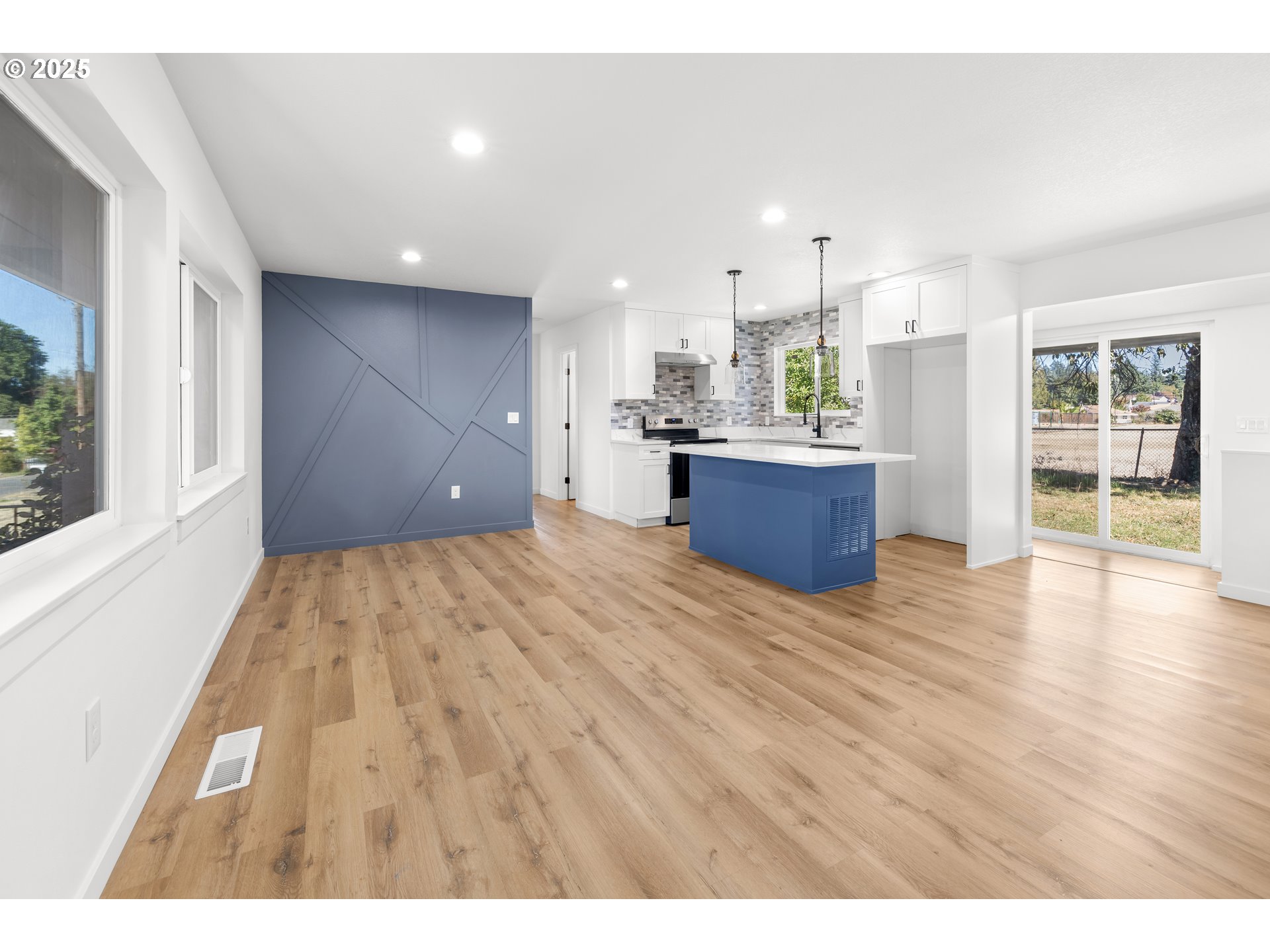 142 Northeast 128th Avenue Portland, OR 97230 - Photo 8 of 43 a view of a kitchen with kitchen island wooden floors wooden floor and window