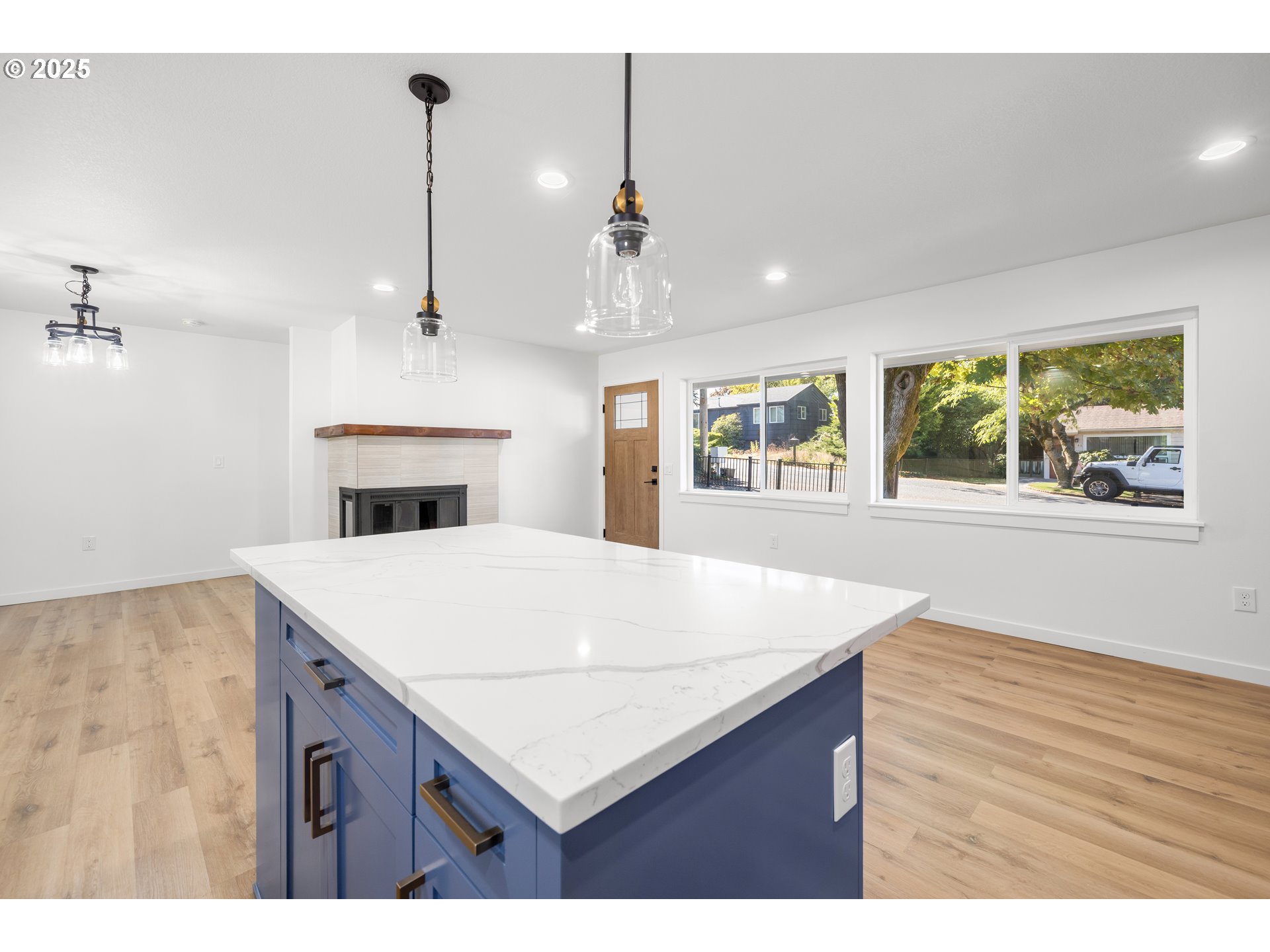 142 Northeast 128th Avenue Portland, OR 97230 - Photo 10 of 43 a open kitchen with kitchen island a stove a sink dishwasher and wooden floor