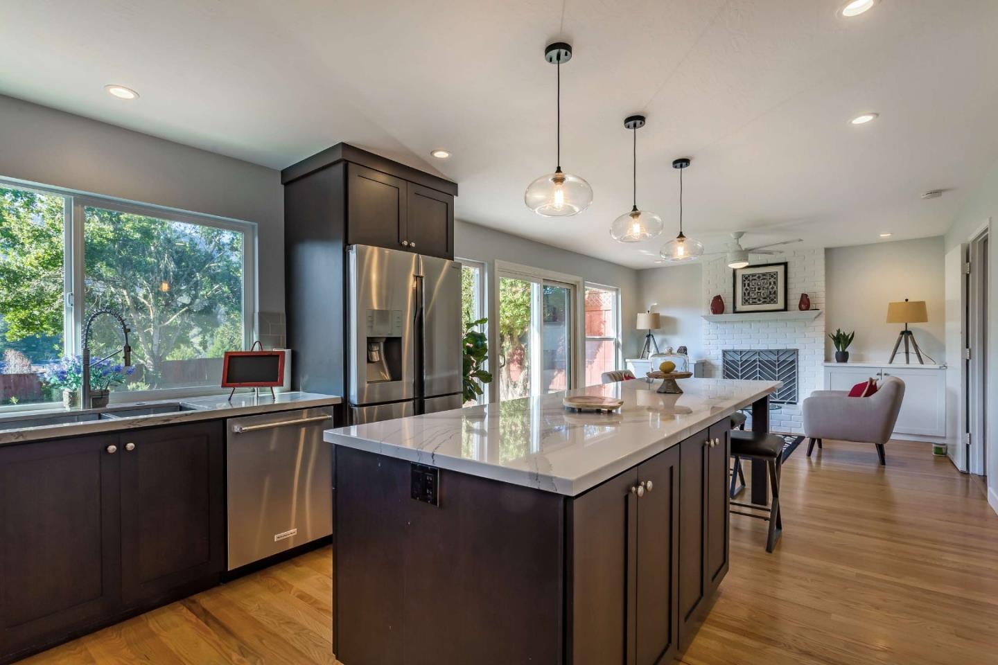 3 Yellowstone Way Pacifica, CA 94044 - Photo 7 of 21 a kitchen with stainless steel appliances granite countertop a sink a stove and a wooden floors