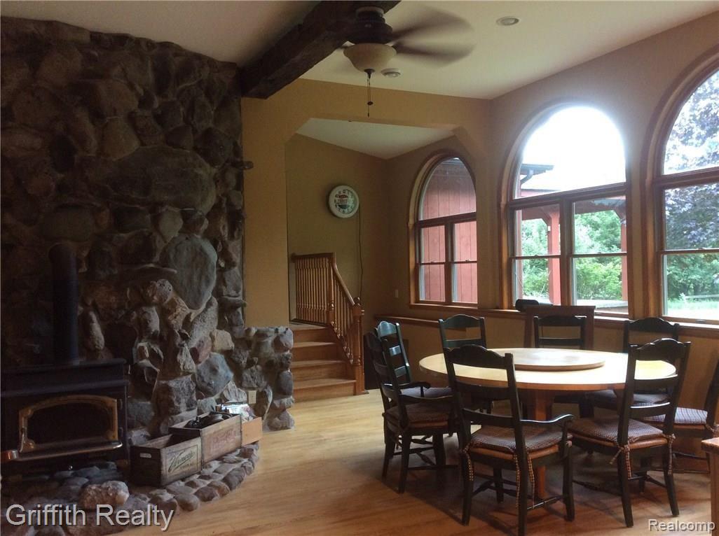 6591 Crofoot Road Fowlerville, MI 48836 - Photo 18 of 51 Open kitchen to hearth room. Loads of windows, wood burner with cut field stone.