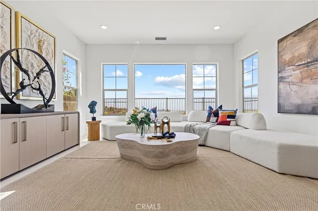 a large white kitchen with a large window and stainless steel appliances