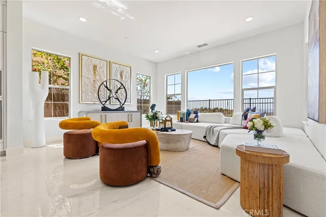 a kitchen with stainless steel appliances granite countertop a table chairs a sink and a window