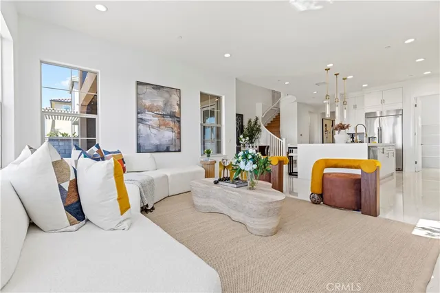 a kitchen with stainless steel appliances kitchen island granite countertop a sink and a refrigerator