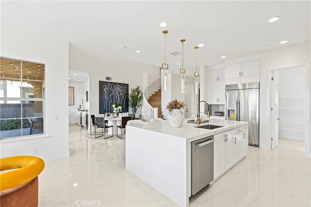 a kitchen with cabinets appliances a sink and a counter top space