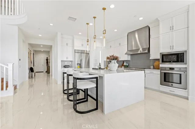 a large kitchen with stainless steel appliances lots of counter top space