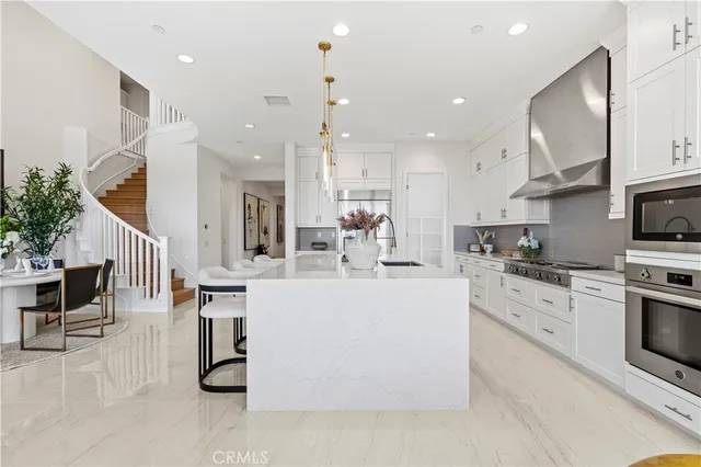 a open kitchen with white cabinets and stainless steel appliances