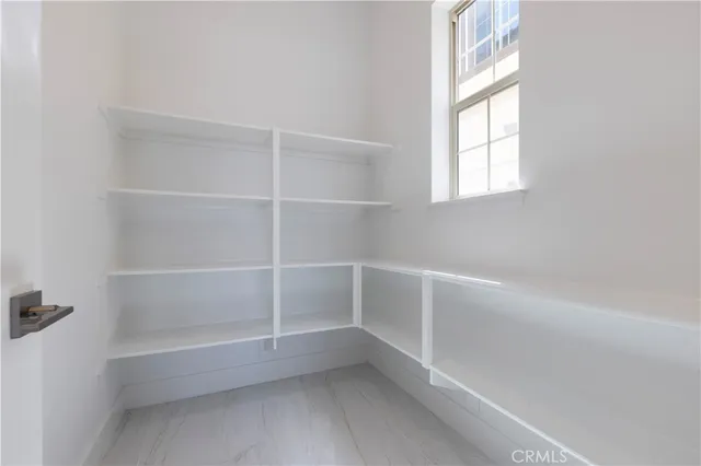 a kitchen with stainless steel appliances kitchen island granite countertop a sink and a refrigerator
