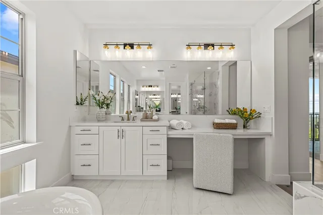 a bathroom with a granite countertop toilet sink and mirror