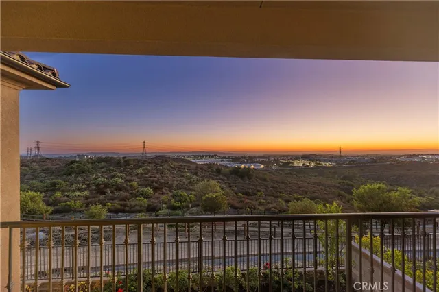 a view of a big house with a big yard and large tree