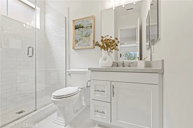 a kitchen with stainless steel appliances kitchen island granite countertop a table chairs and a sink