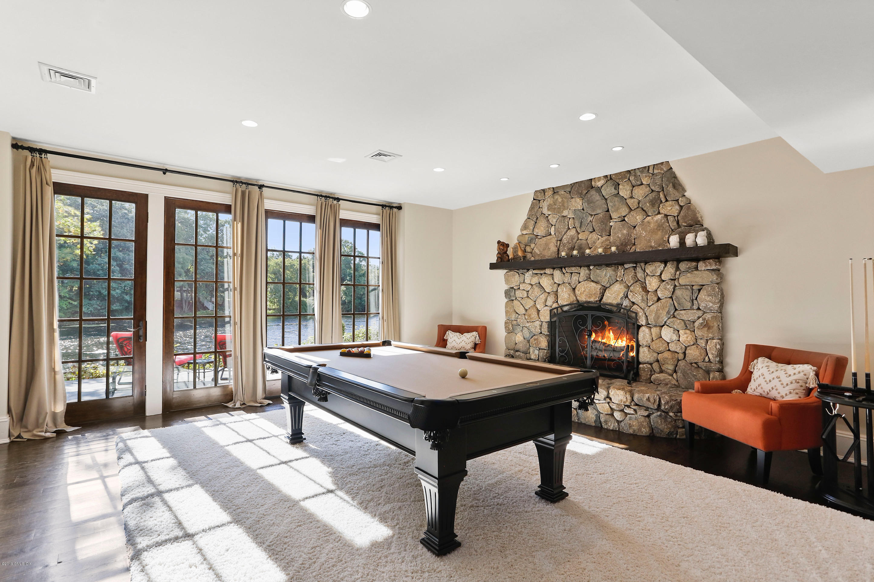 271 Valley Road Cos Cob, CT 06807 - Photo 13 of 42 a living room with furniture a table and a fireplace