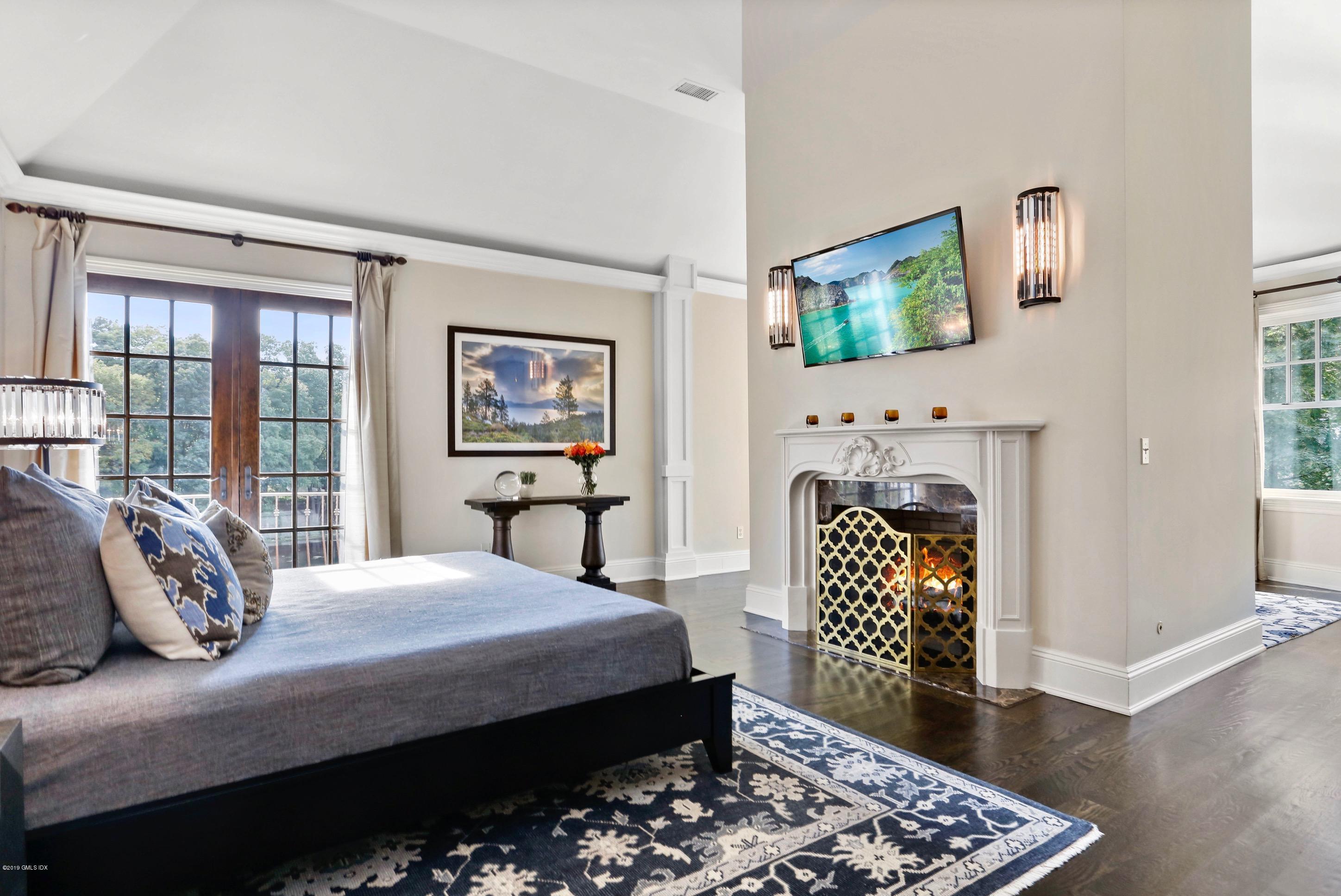 271 Valley Road Cos Cob, CT 06807 - Photo 18 of 42 a bedroom with a bed a mirror on dresser and a window