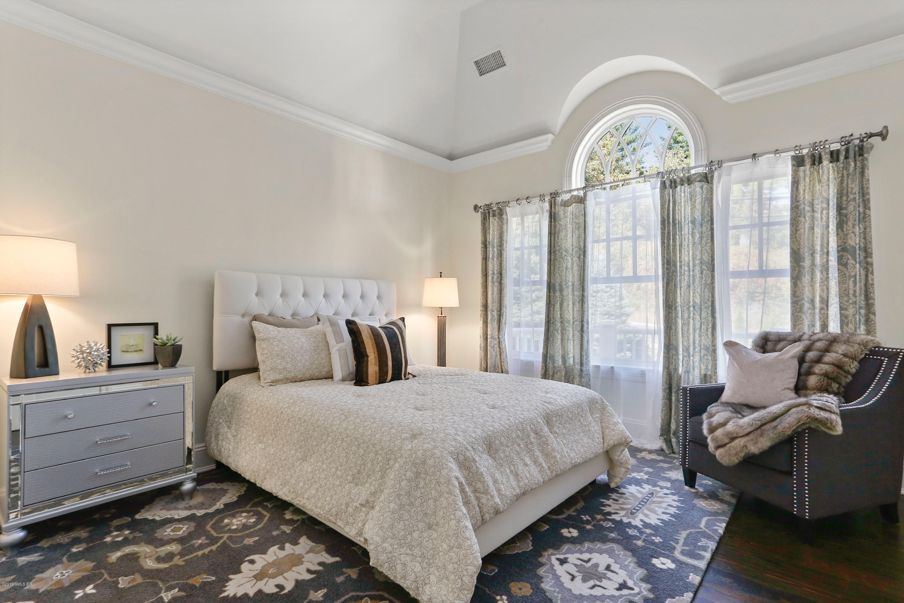 271 Valley Road Cos Cob, CT 06807 - Photo 28 of 42 a bedroom with a bed and wooden floor