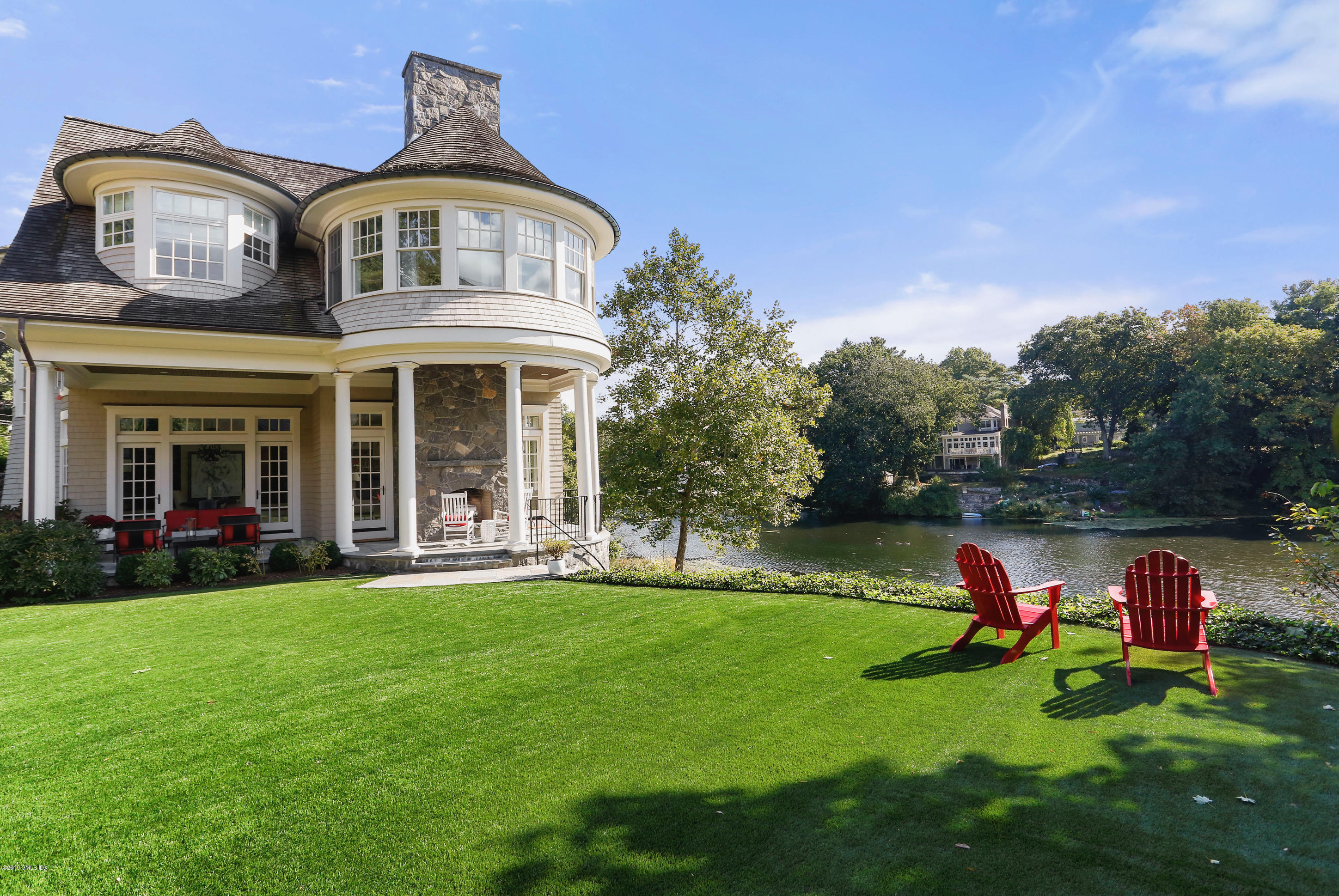 271 Valley Road Cos Cob, CT 06807 - Photo 34 of 42 a front view of a house with a garden and trees
