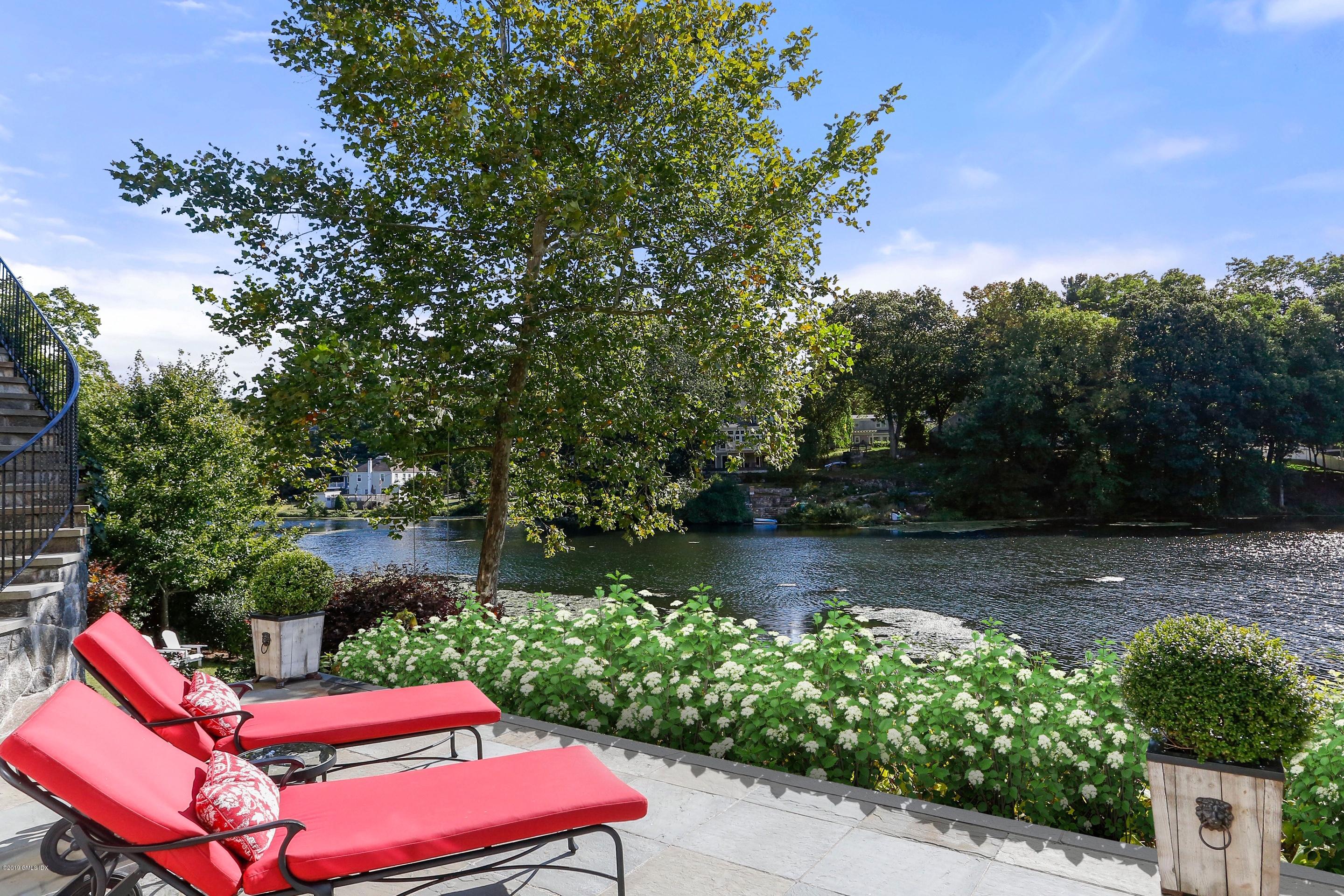 271 Valley Road Cos Cob, CT 06807 - Photo 40 of 42 a view of a yard with a bench in a patio