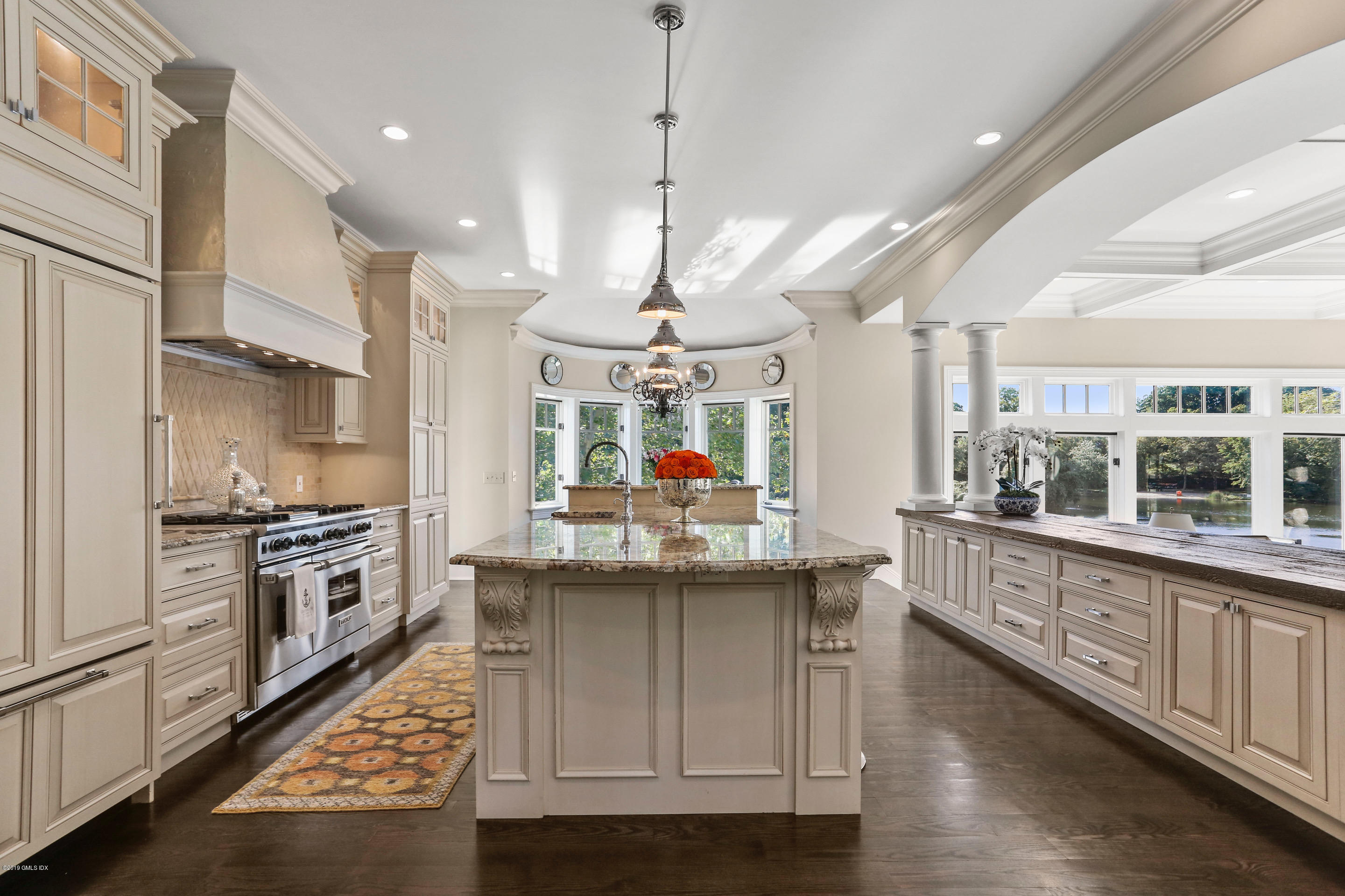 271 Valley Road Cos Cob, CT 06807 - Photo 8 of 42 a kitchen with stainless steel appliances granite countertop a sink a stove and a wooden floor