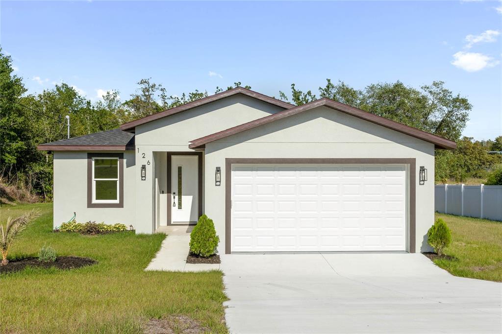 126 Canby Circle Spring Hill, FL 34606 - Photo 1 of 37 a front view of a house with a yard and garage
