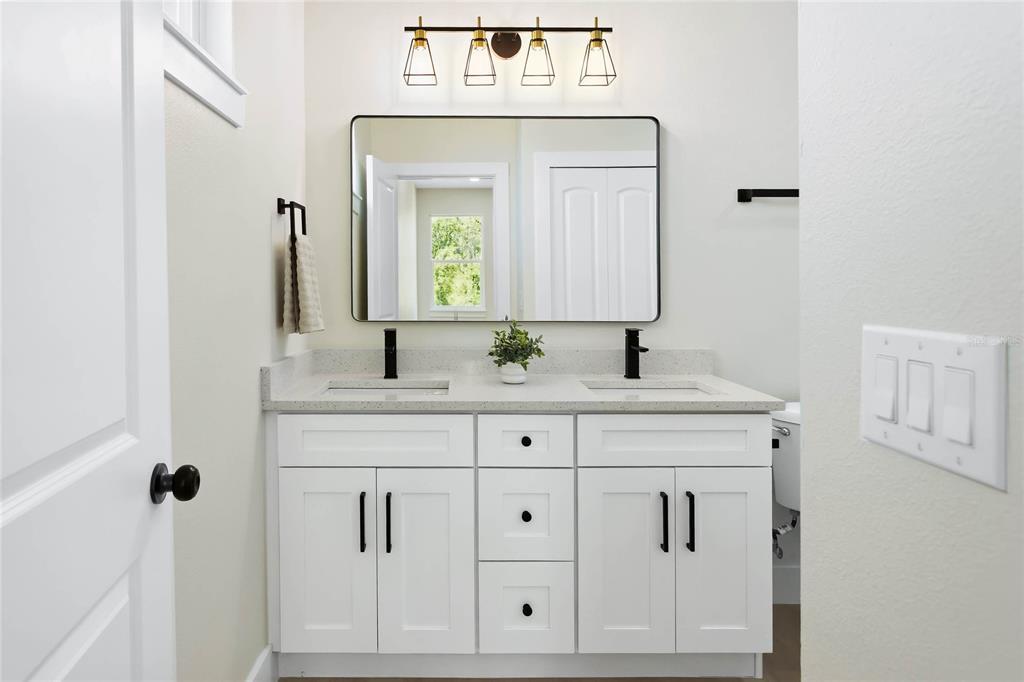 126 Canby Circle Spring Hill, FL 34606 - Photo 18 of 37 a bathroom with vanity a sink and mirror