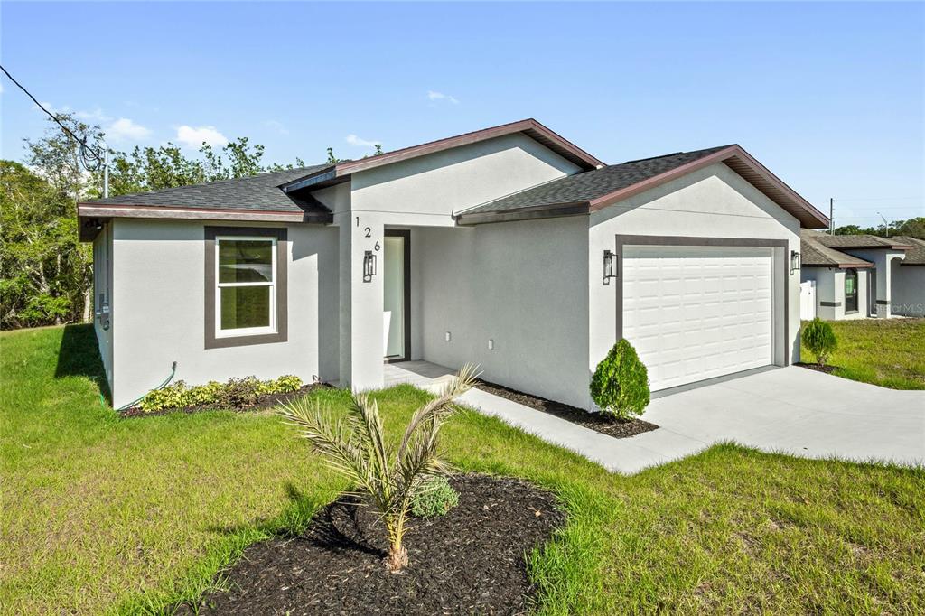 126 Canby Circle Spring Hill, FL 34606 - Photo 2 of 37 a front view of a house with a yard
