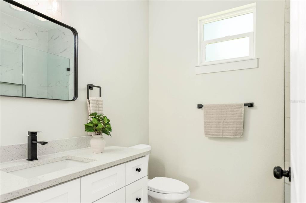126 Canby Circle Spring Hill, FL 34606 - Photo 22 of 37 a bathroom with a toilet sink and mirror