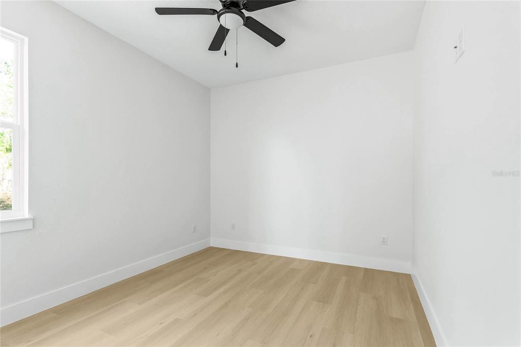 126 Canby Circle Spring Hill, FL 34606 - Photo 25 of 37 an empty room with a window and a ceiling fan