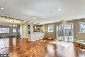 a view of an empty room with glass door and a window