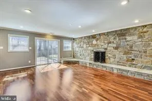 a view of an empty room with a fireplace and a window