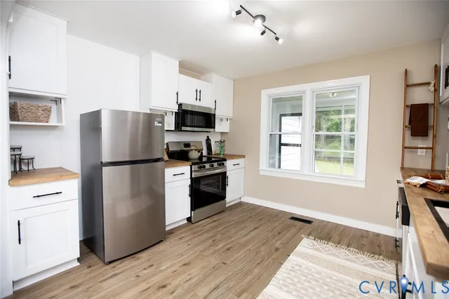 a kitchen with stainless steel appliances granite countertop a stove and a sink