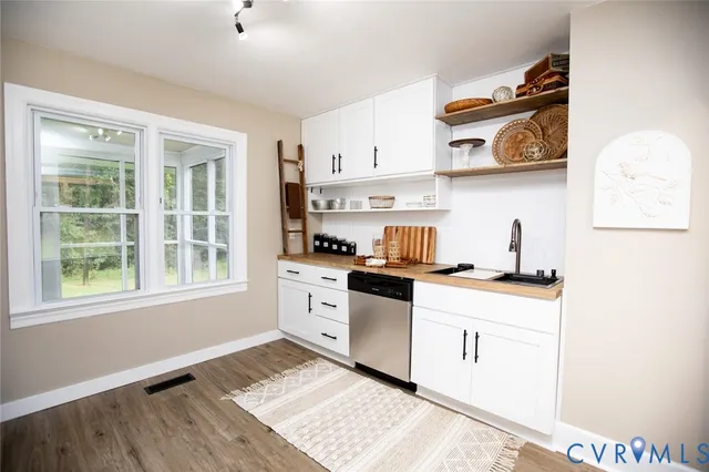 a kitchen with stainless steel appliances a white stove and cabinets