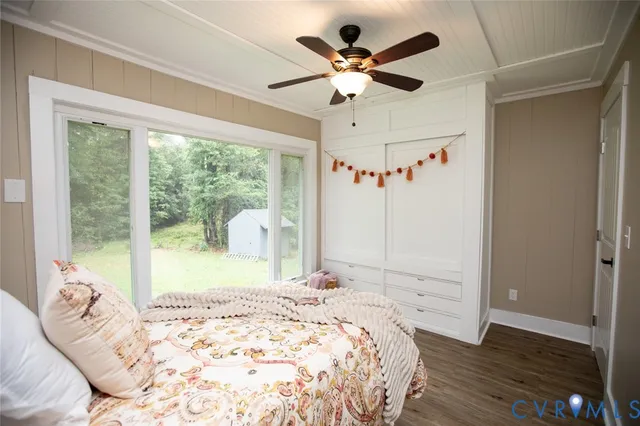 a bedroom with a bed and a potted plant