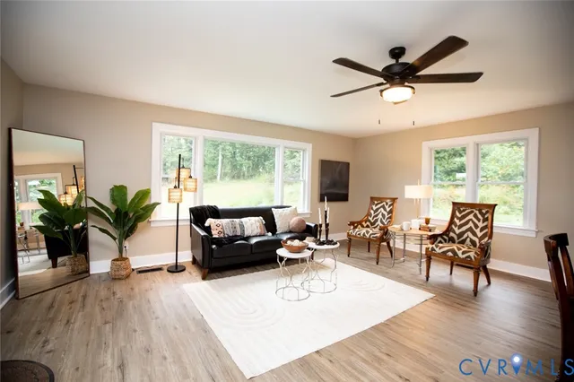a living room with furniture dining table and a chandelier
