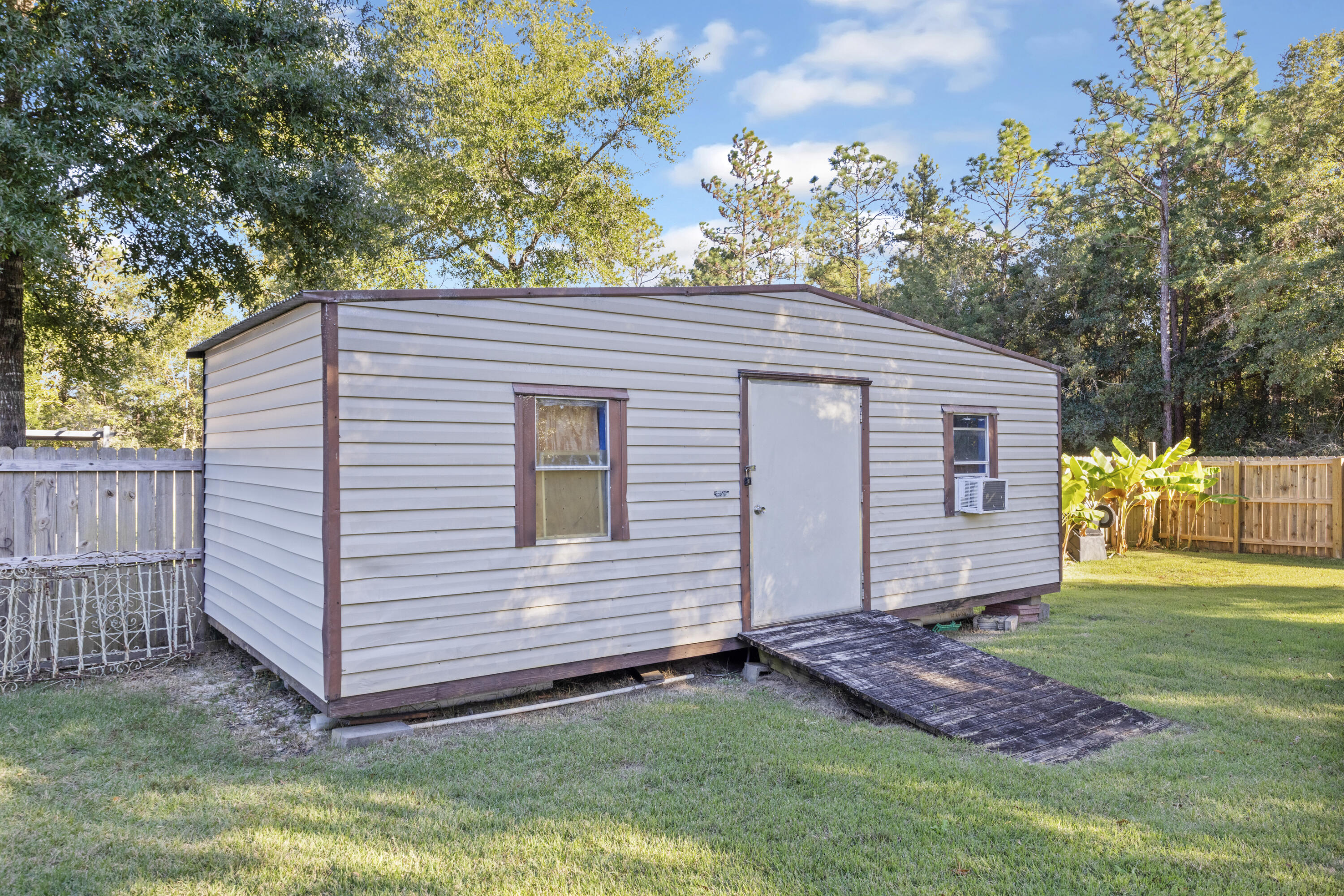 5774 Wayne Rogers Road Crestview, FL 32539 - Photo 52 of 63 a view of a house with a yard