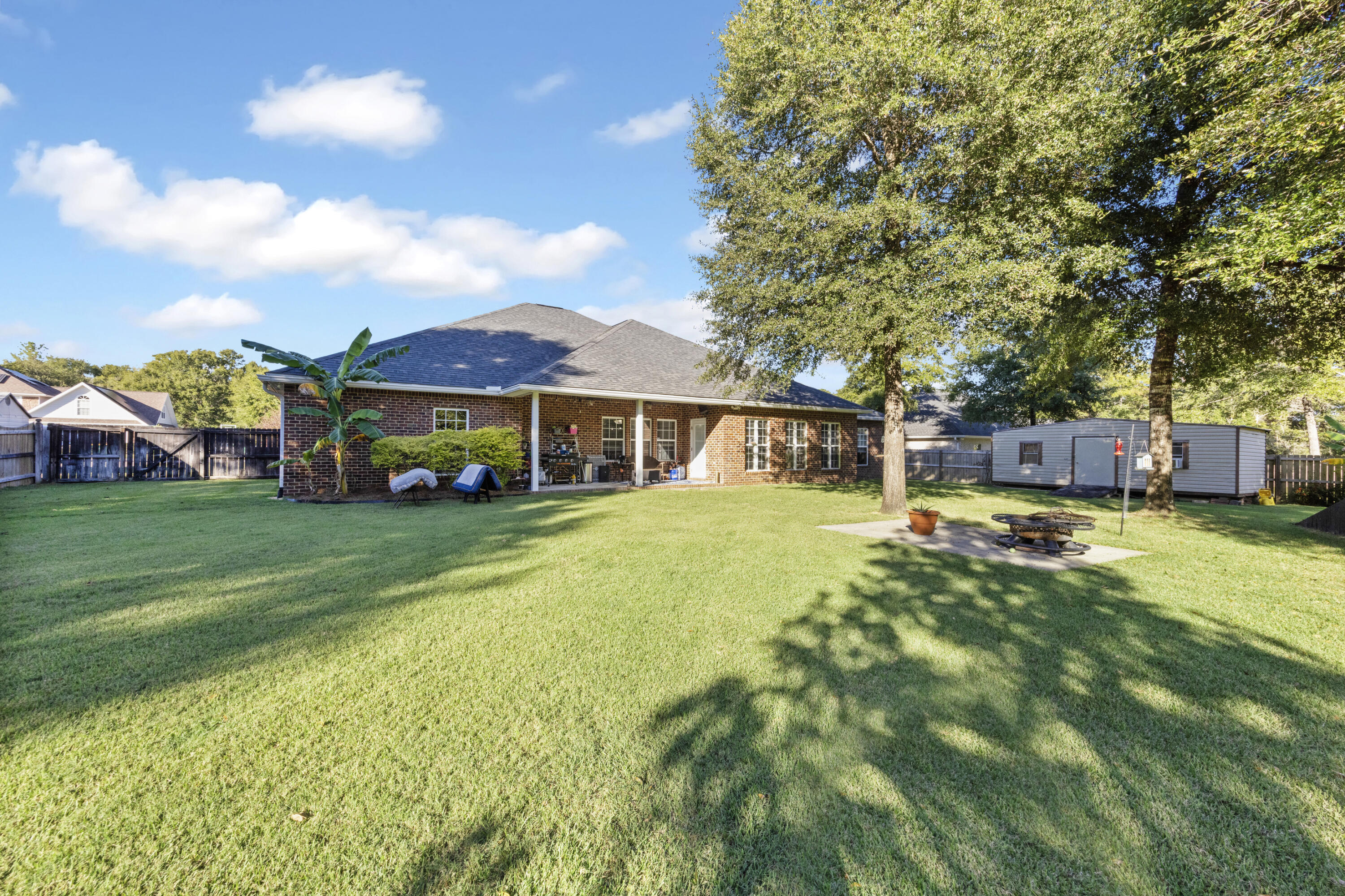 5774 Wayne Rogers Road Crestview, FL 32539 - Photo 56 of 63 a front view of a house with a yard table and chairs