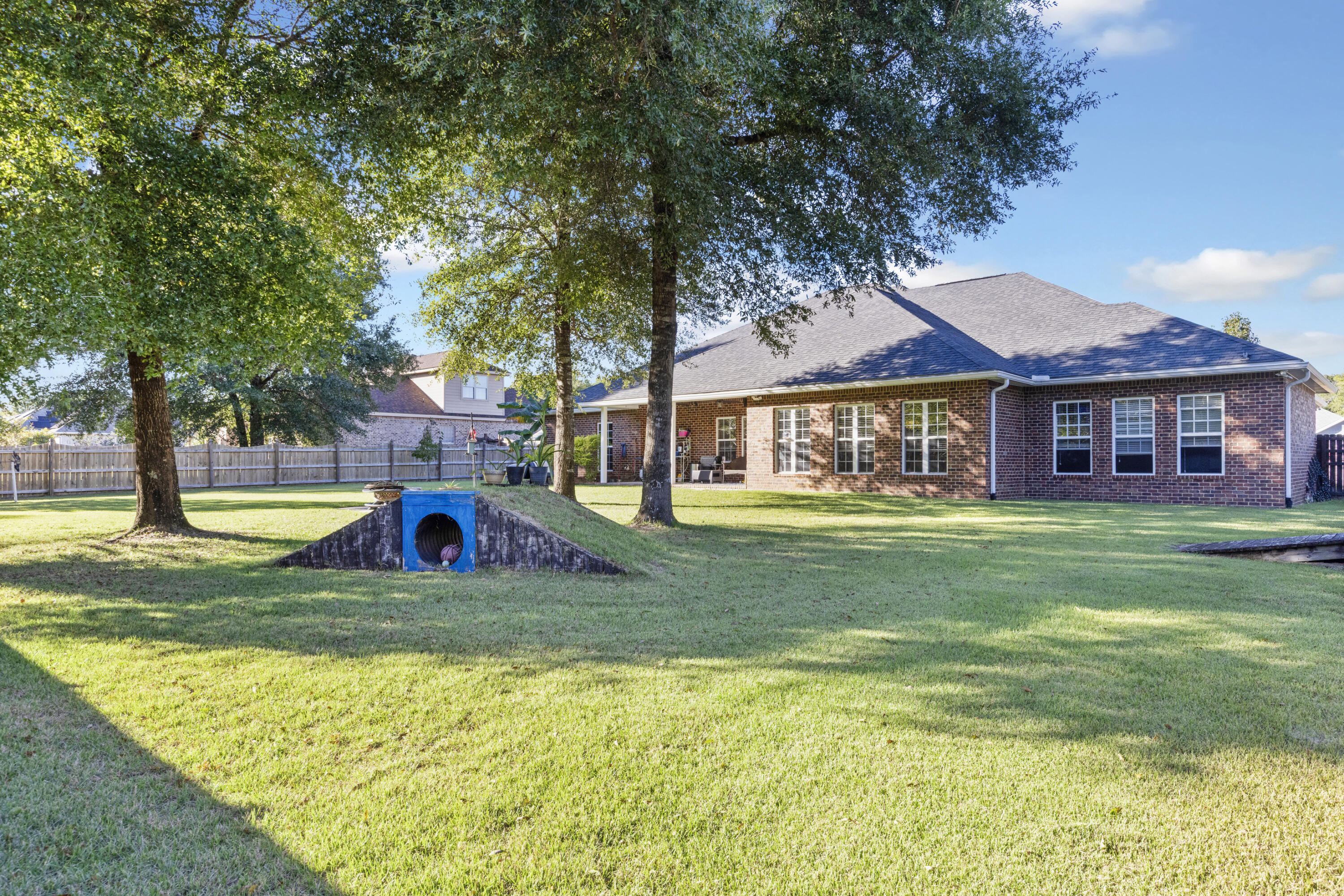 5774 Wayne Rogers Road Crestview, FL 32539 - Photo 57 of 63 a view of swimming pool with lawn chairs and large trees