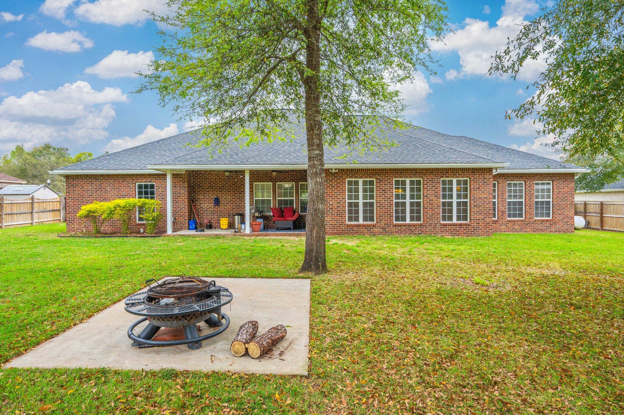 5774 Wayne Rogers Road Crestview, FL 32539 - Photo 59 of 63 a front view of a house with a yard and garage