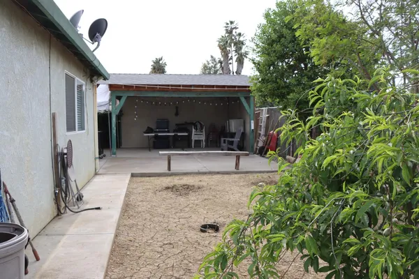 a view of backyard with wheel chair and potted plants