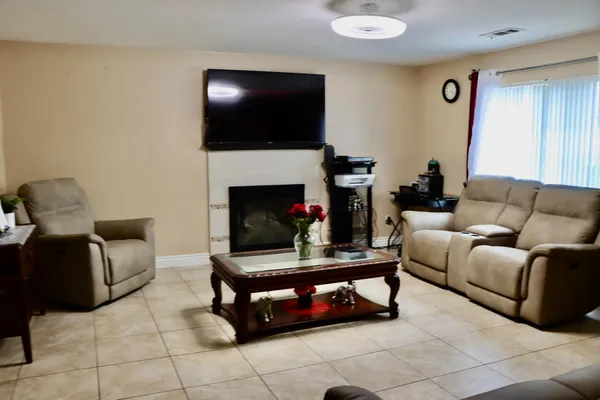 a living room with furniture and a fireplace