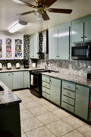 a kitchen with stainless steel appliances granite countertop a sink and cabinets
