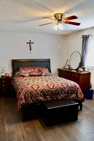a bed sitting in a bedroom next to a chandelier
