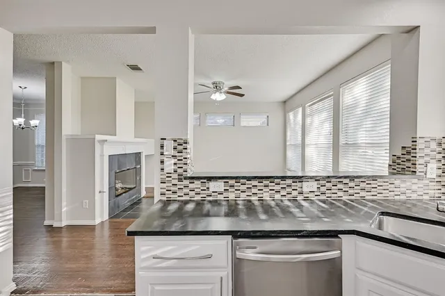a bathroom with a granite countertop sink a large mirror and a shower