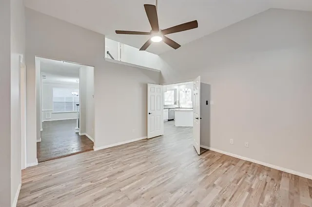 a view of empty room with wooden floor