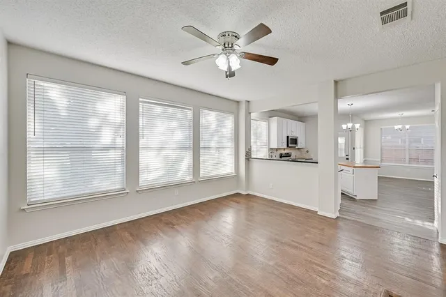 a view of an empty room with a kitchen