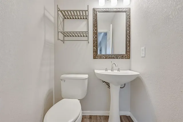 a bathroom with a sink a mirror and a toilet