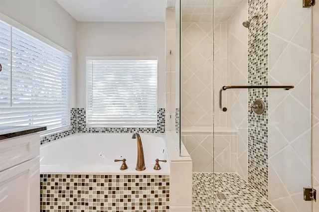 a bathroom with a bathtub and shower